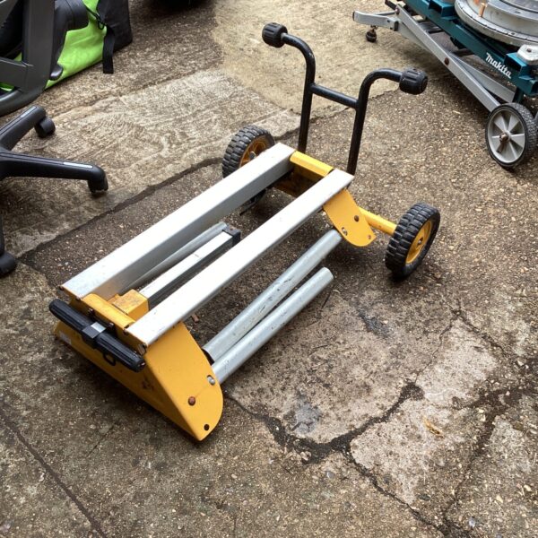 Heavy-duty De Walt rolling saw bench for workshop use.