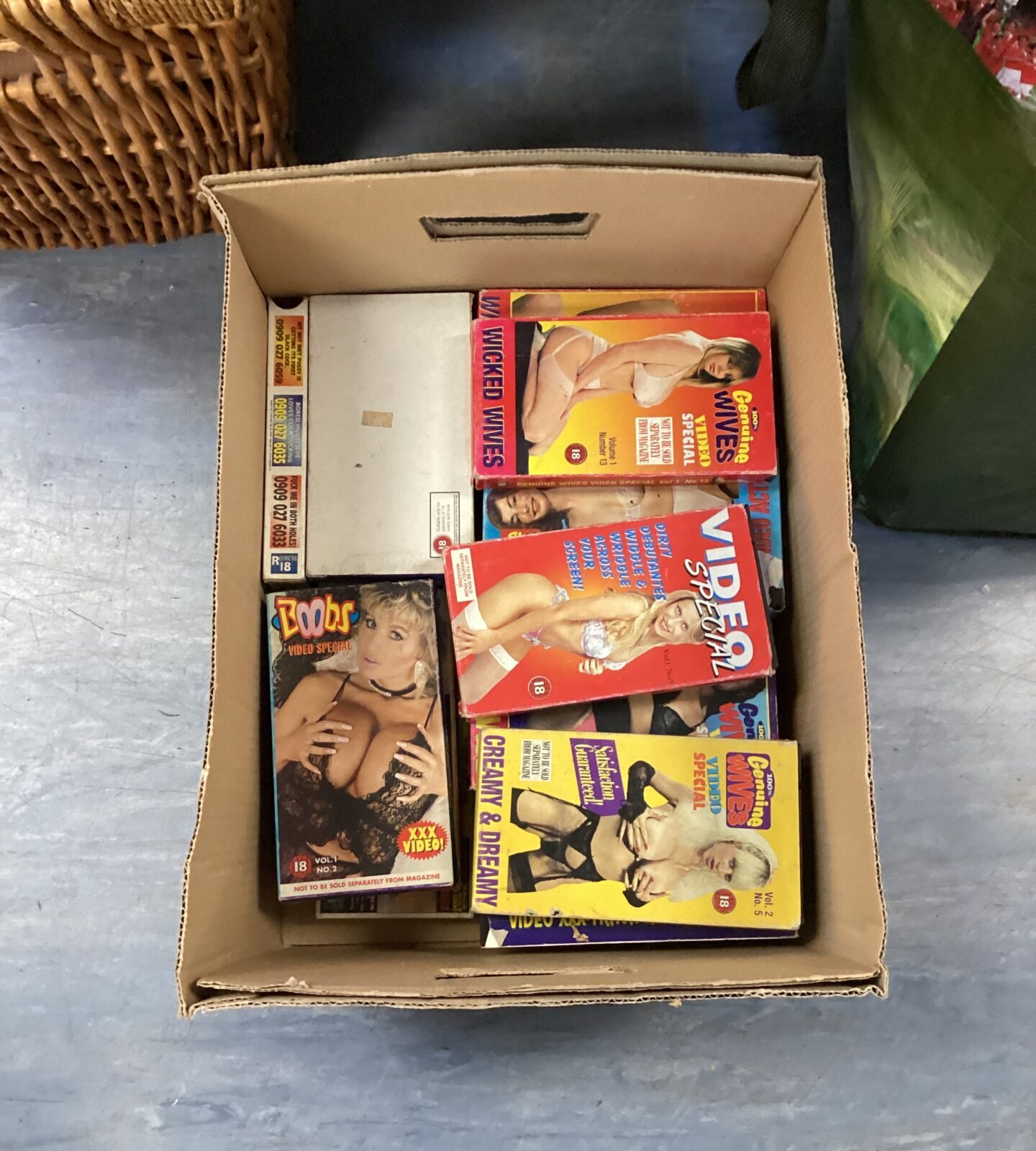 Box of retro adult VHS tapes