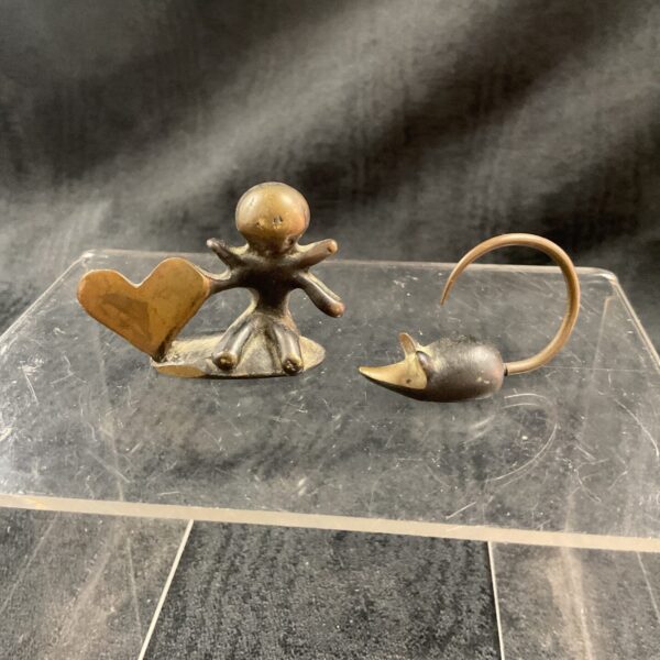 Vintage Walter Bosse bronze mouse sculpture on a reflective surface.