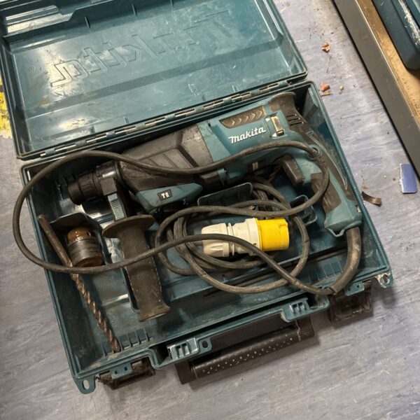 Open case of a used Makita HR2630 110v drill.