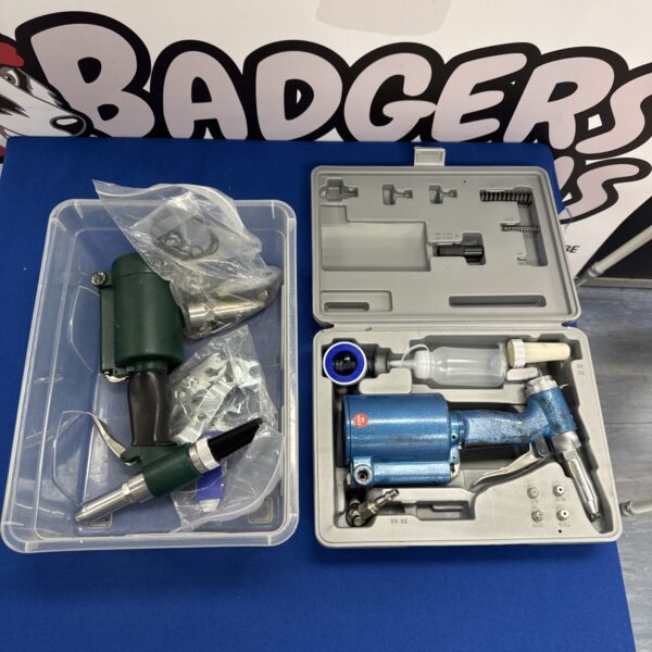 Pneumatic rivet gun set with accessories and spanners for fastening materials.