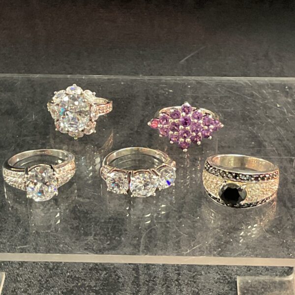 Silver ring set with white and amethyst coloured stones.