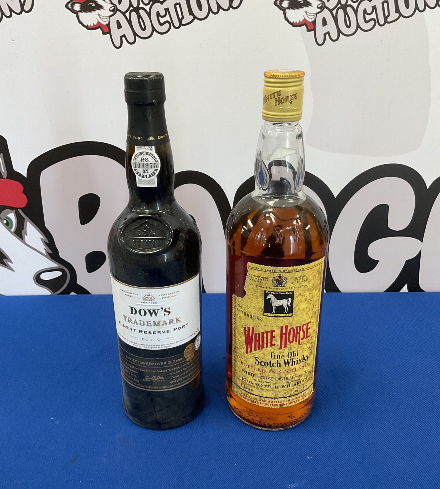 Sealed bottles of Dows trademark finest reserve port & white horse whisky
