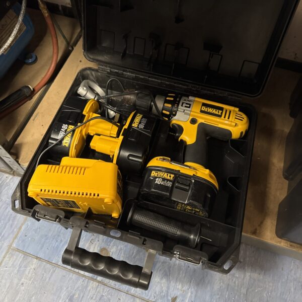 Dewalt cordless drill with three batteries and charger.