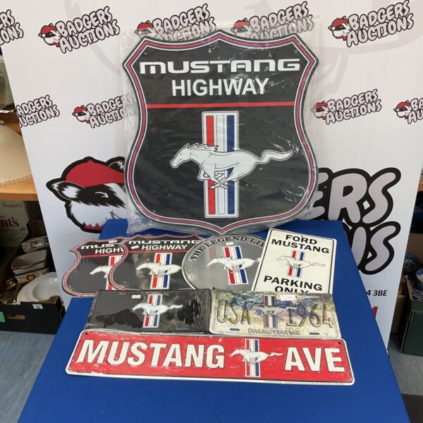 Lot of eight new tin Mustang signs for collectors.