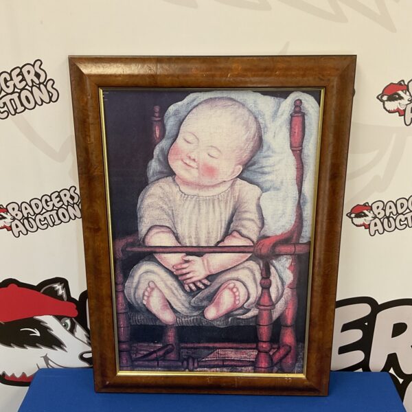 Framed print of a baby in red chair by anonymous American artist