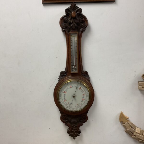 Antique oak cased mercury barometer for weather forecasting.