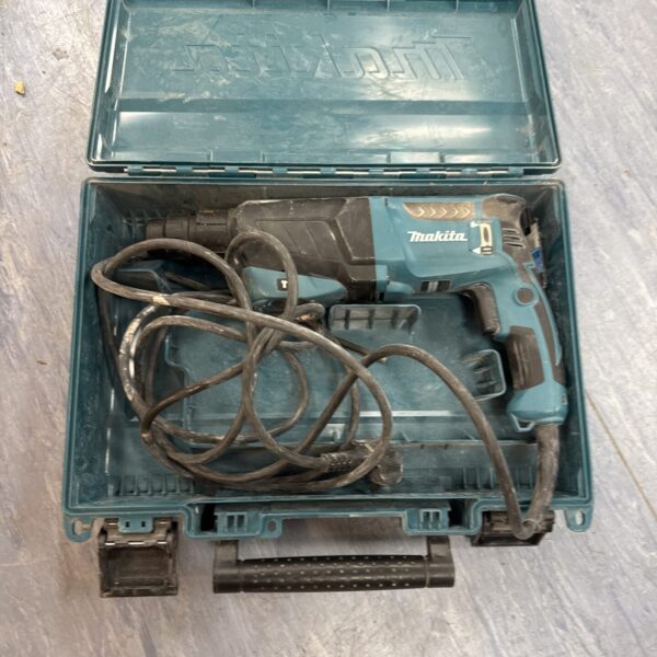 Open case of a used Makita HR2630 rotary hammer drill.