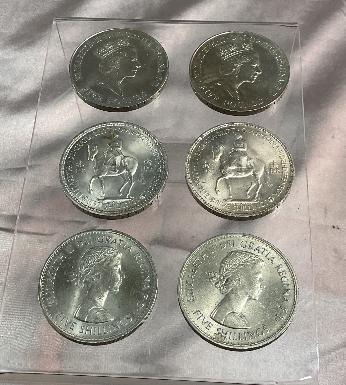 Two Five pound coins and four five shillings coins