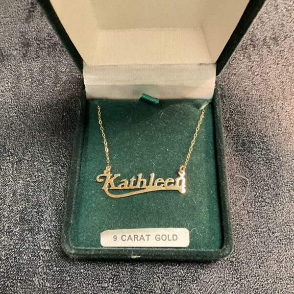 Vintage 9ct gold necklace with "Kathleen" pendant on display.
