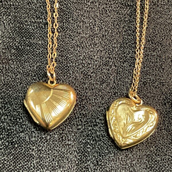 Vintage 9ct gold heart locket with ribbed detailing on a chain.