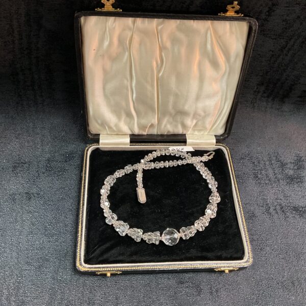 Vintage rock crystal necklace displayed in its original presentation box.