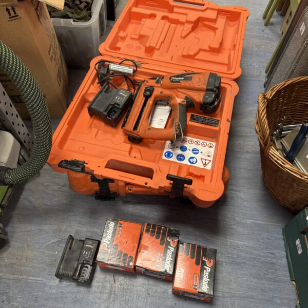Paslode cordless staple gun kit with staples and charger.