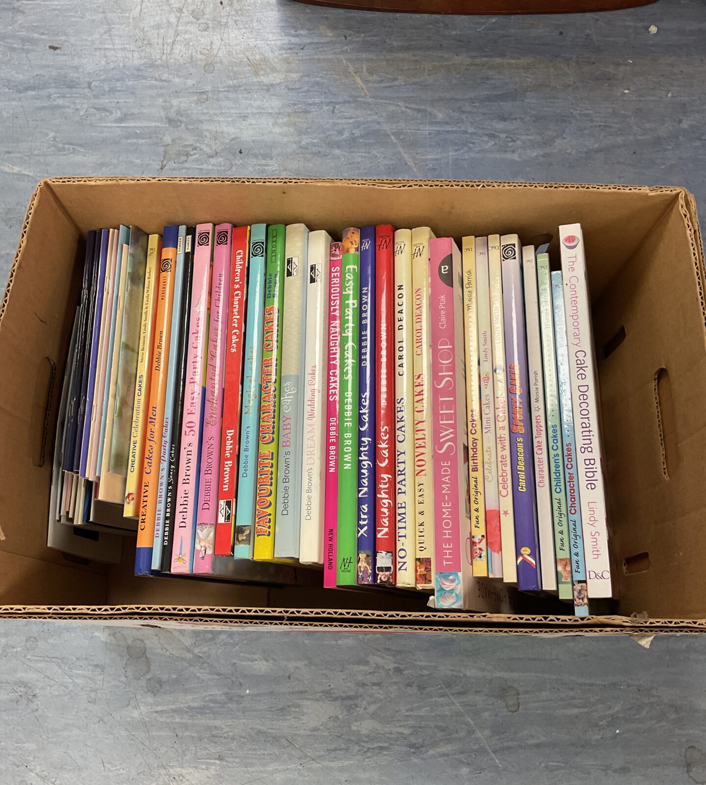 Box full of cake making cookery books