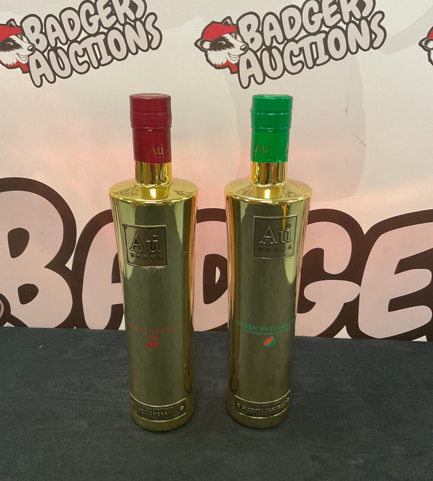 Two sealed bottles of au vodka including red cherry & green watermelon