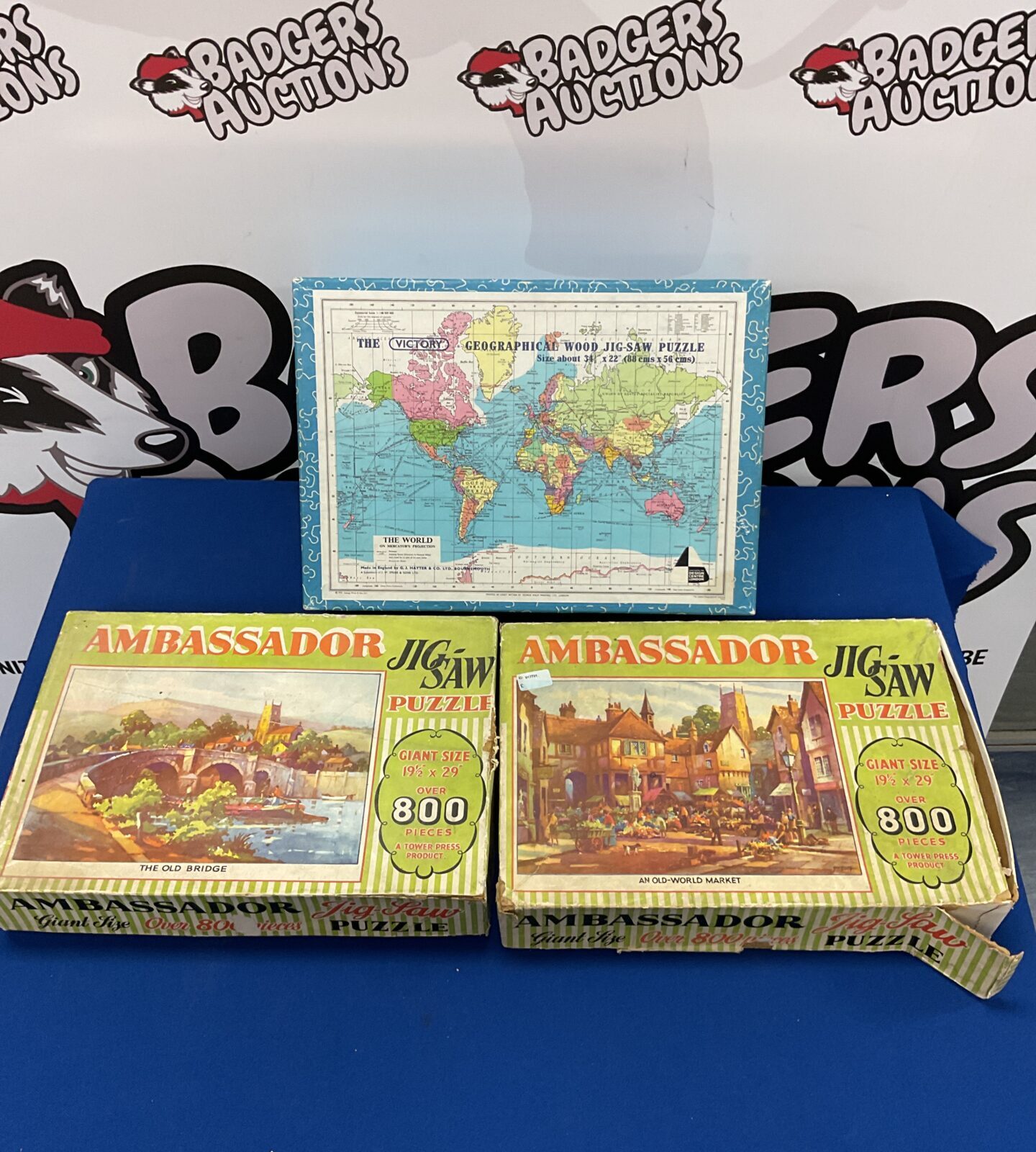 Three vintage jigsaw puzzles including ambassador