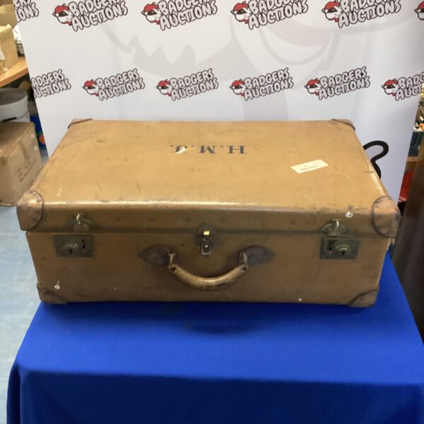 Large vintage H.M.J travel trunk with aged appearance.