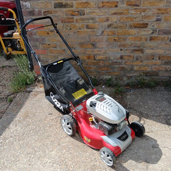 Cobra DG350V petrol lawnmower in a garden setting.