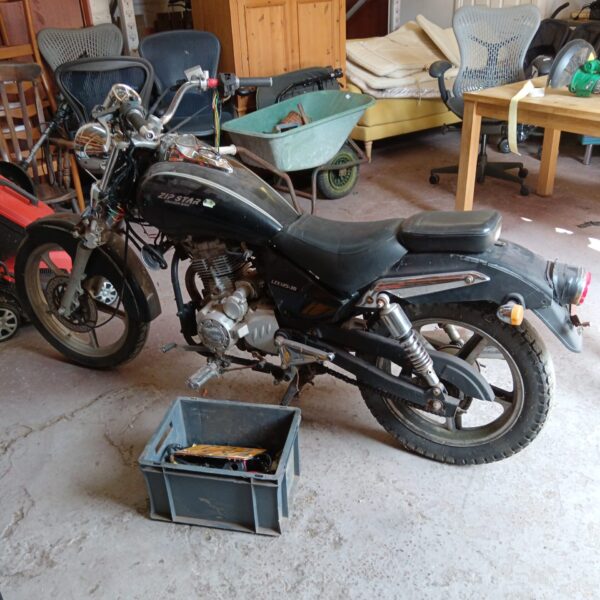 Black Zip Star 125cc motorbike side view, restoration project.