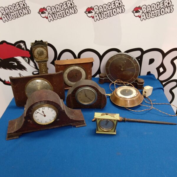 Vintage clock collection including a Smiths electric clock on display.