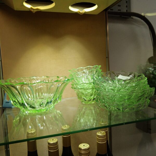 Vintage uranium glass bowl set with green serving dishes.