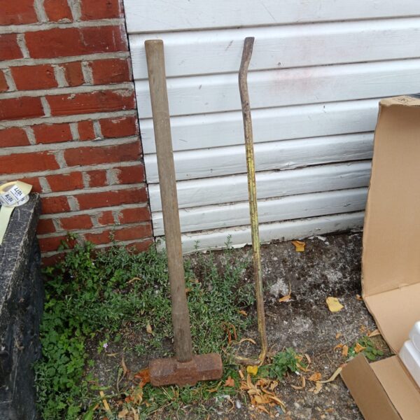 Vintage sledge hammer and crowbar set showing signs of wear.