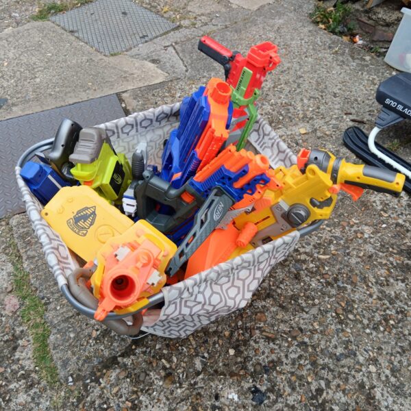 Crate filled with a large lot of Nerf guns and blasters.