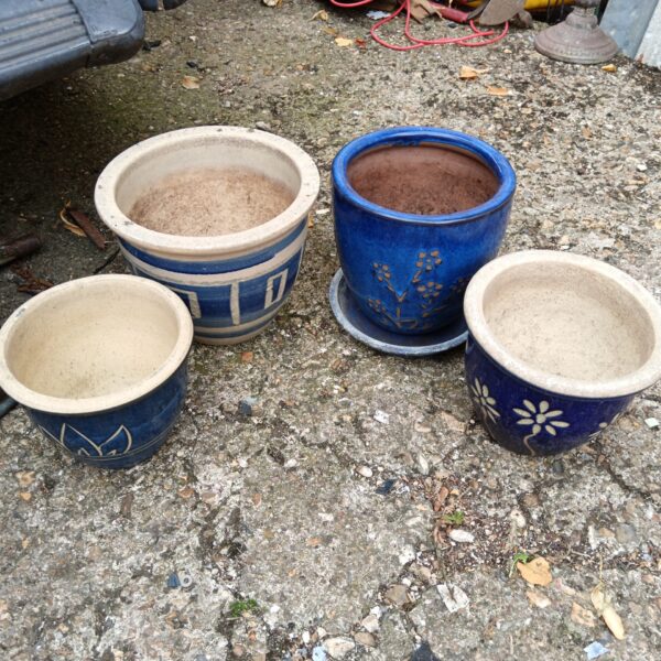 Lot of four blue glazed ceramic plant pots for garden decor.