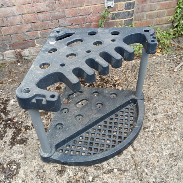Heavy-duty garden tool storage stand for long-handled tools.