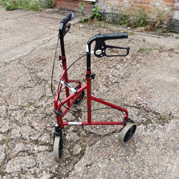 Red Drive mobility walker with three wheels, vintage assistive device.