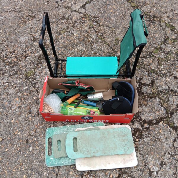 Used gardening kneeler and tool set with various implements.