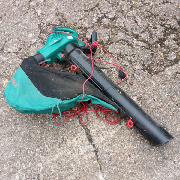 Side view of a used Bosch garden leaf vacuum with collection bag.