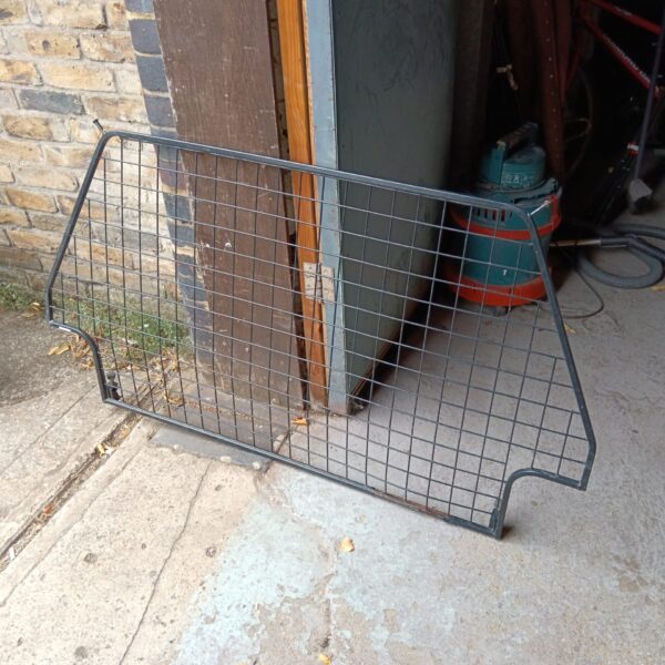 Metal mesh Land Rover dog guard for pet safety.