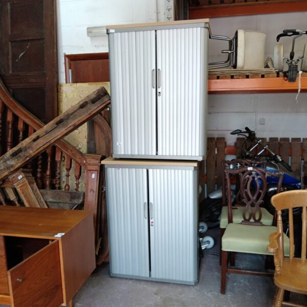 Vintage metal roller front office cabinet pair for storage.