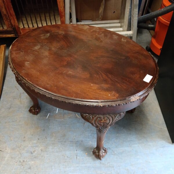 Antique mahogany magazine table with claw feet.
