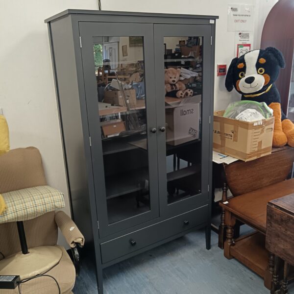Modern grey glass display cabinet with illuminated interior.