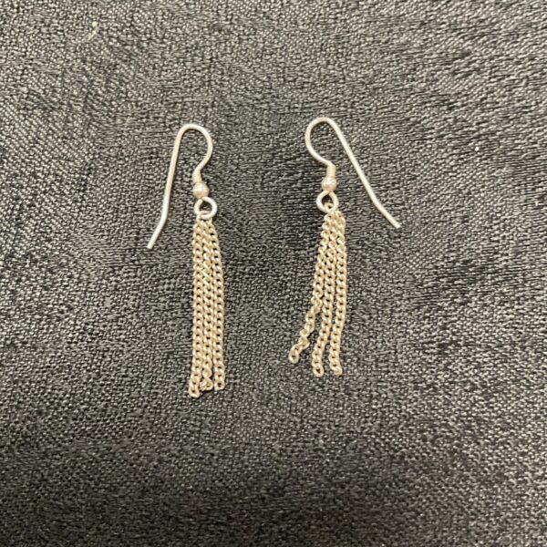 Close-up of elegant silver drop chain earrings.