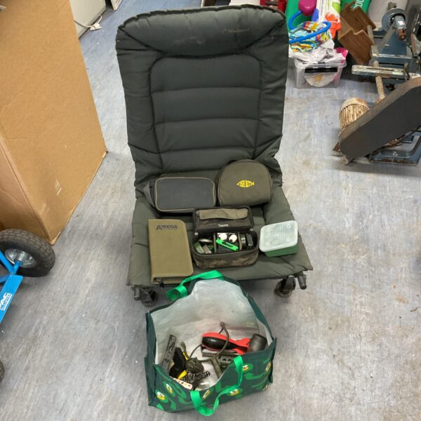 Wychwood fishing chair with tackle and storage cases displayed.