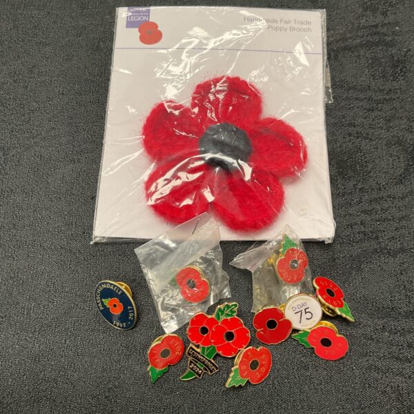 Collection of British Legion Poppy badges for remembrance.