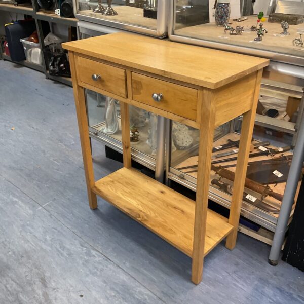 Front view of a classic oak console table with two drawers.