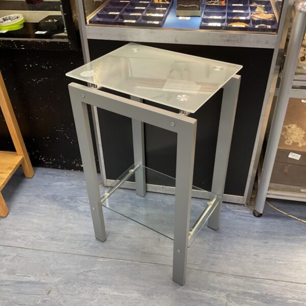Sleek modern side table with glass top and metal frame.