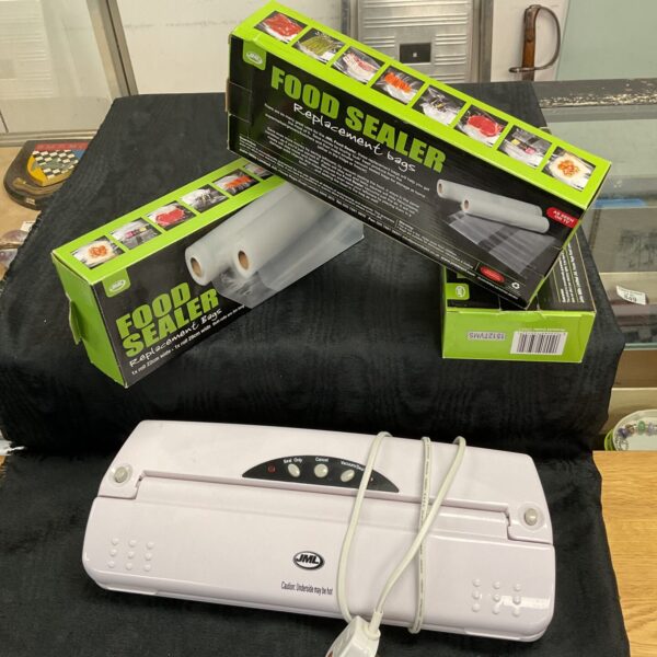 Jml food sealer machine with included food bags for preservation.