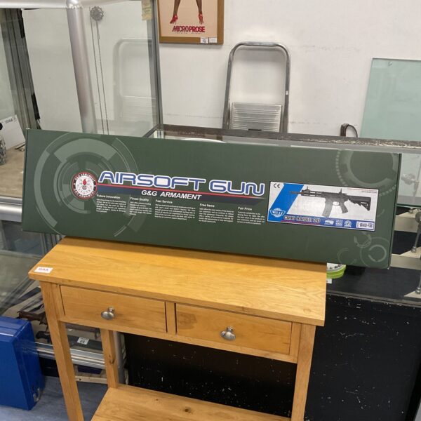 G&G Cm16 Raider 2.0 airsoft gun with accessories on a table.