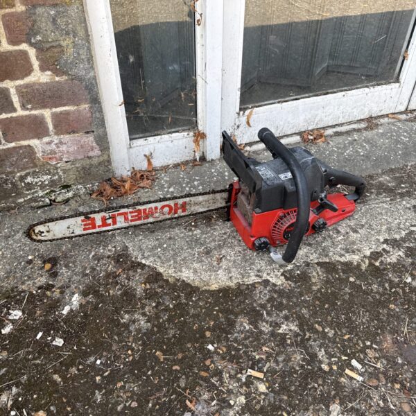 Vintage Homelite 300 chainsaw in used condition.