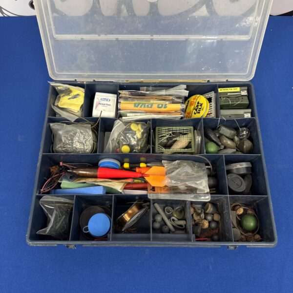 Open tackle box filled with carp fishing terminal tackle and rigs.
