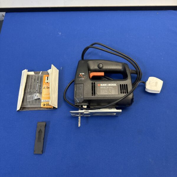 Vintage Black & Decker electric jigsaw with spare blades for DIY projects.
