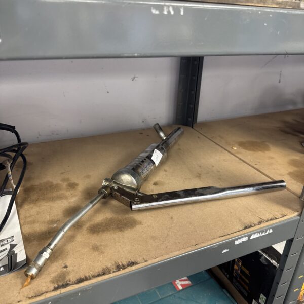 Vintage Japanese grease gun for automotive lubrication.
