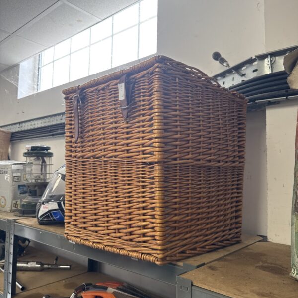 Large wicker hamper basket for laundry and storage.
