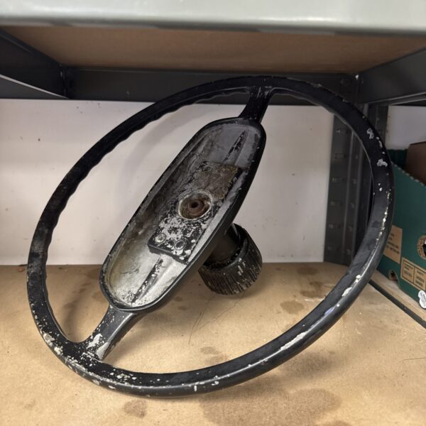 Vintage Jaguar steering wheel showing wear and patina.