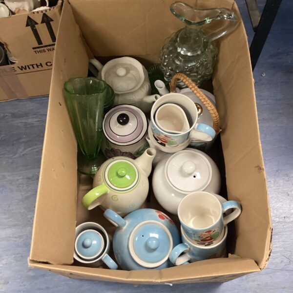 Mixed lot of vintage teapots, mugs, and a glass jug.